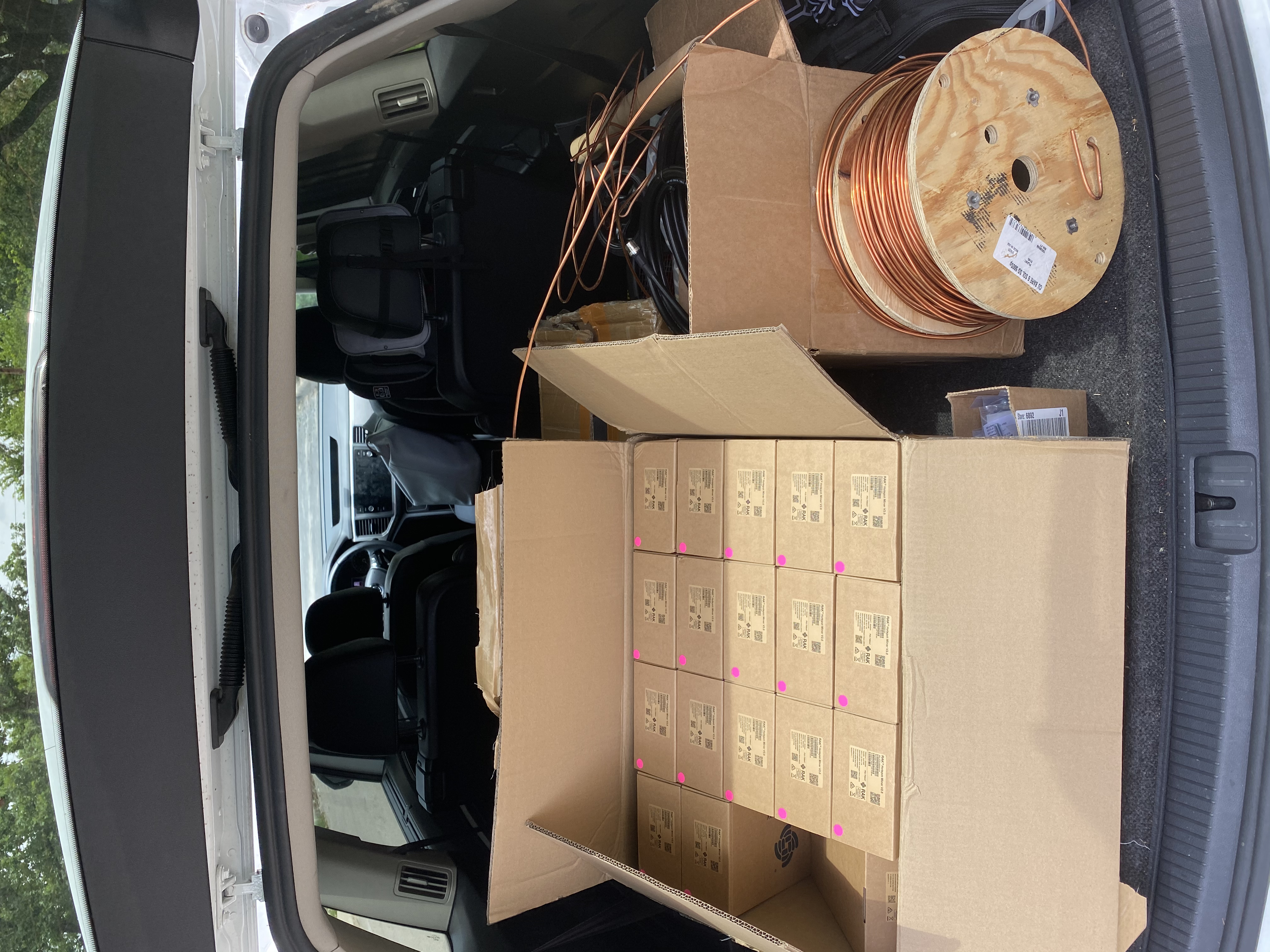 A car full of little boxes, cables, and a spool of copper wire