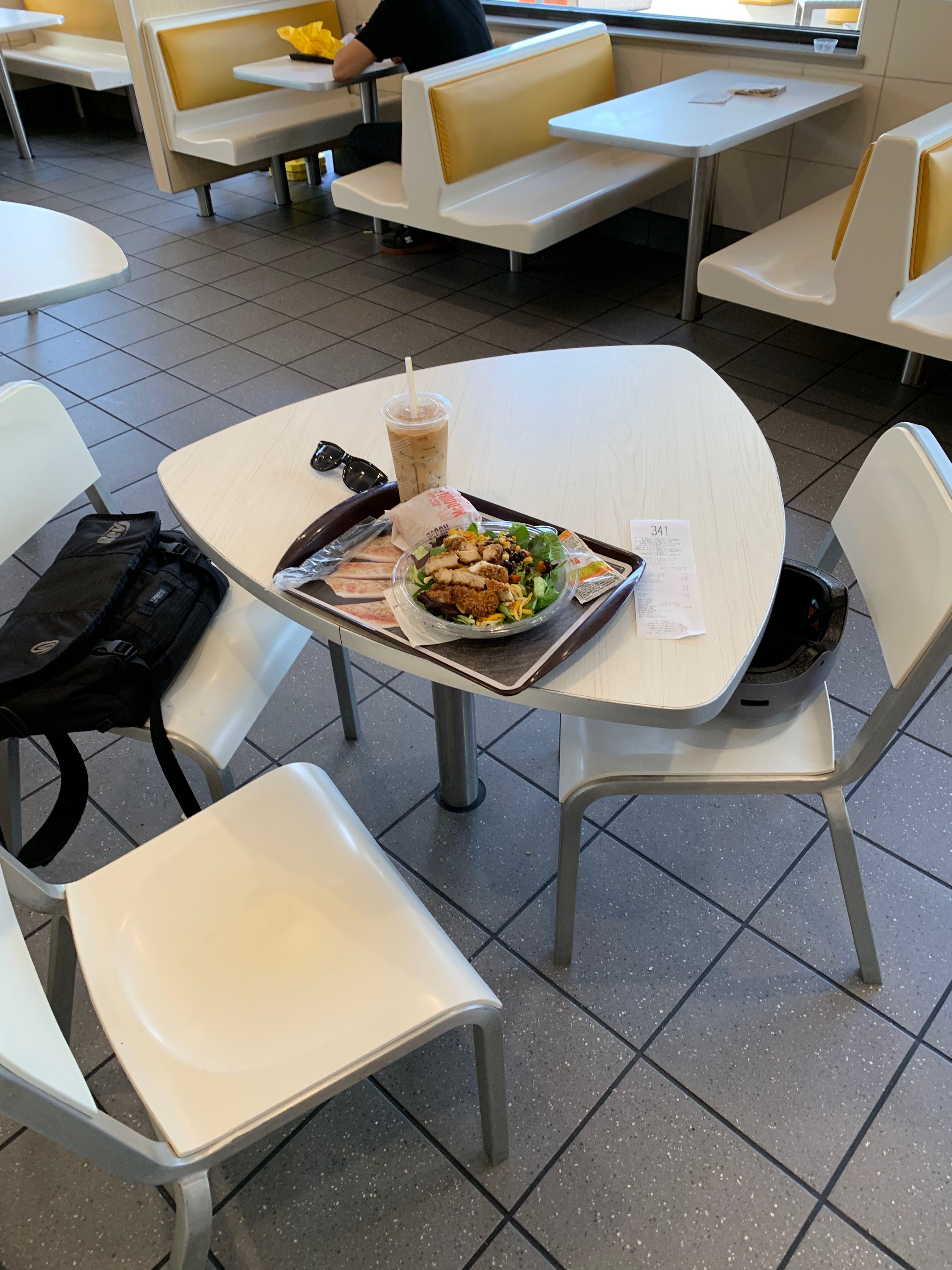 Tray of food next to computer bag